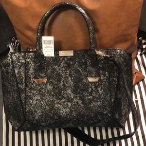 Henri Bendel oil slick handbag with strap. Gold tone hardware.